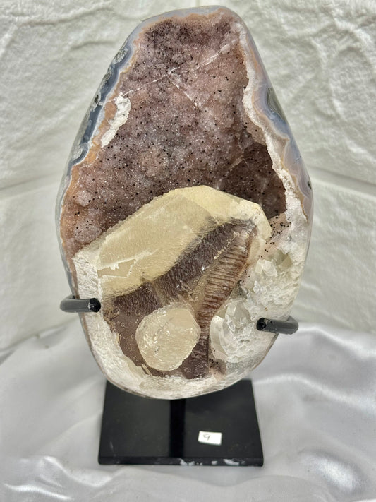 Pink amethyst with calcite on stand from Brazil