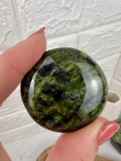 1 dark green serpentine “cookie” flat stone