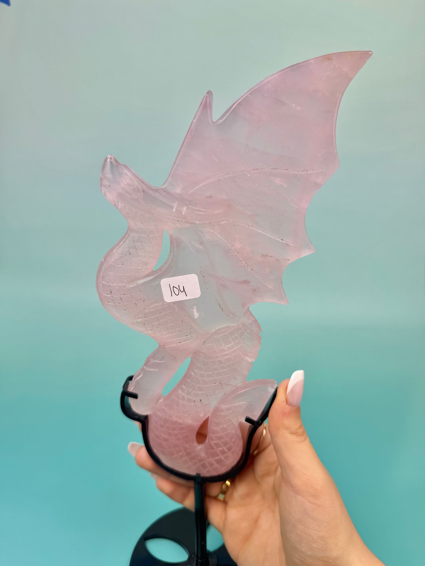 Stunning rose quartz dragon on black stand