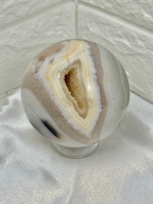 Beautiful banded agate sphere with druzy from Brazil
