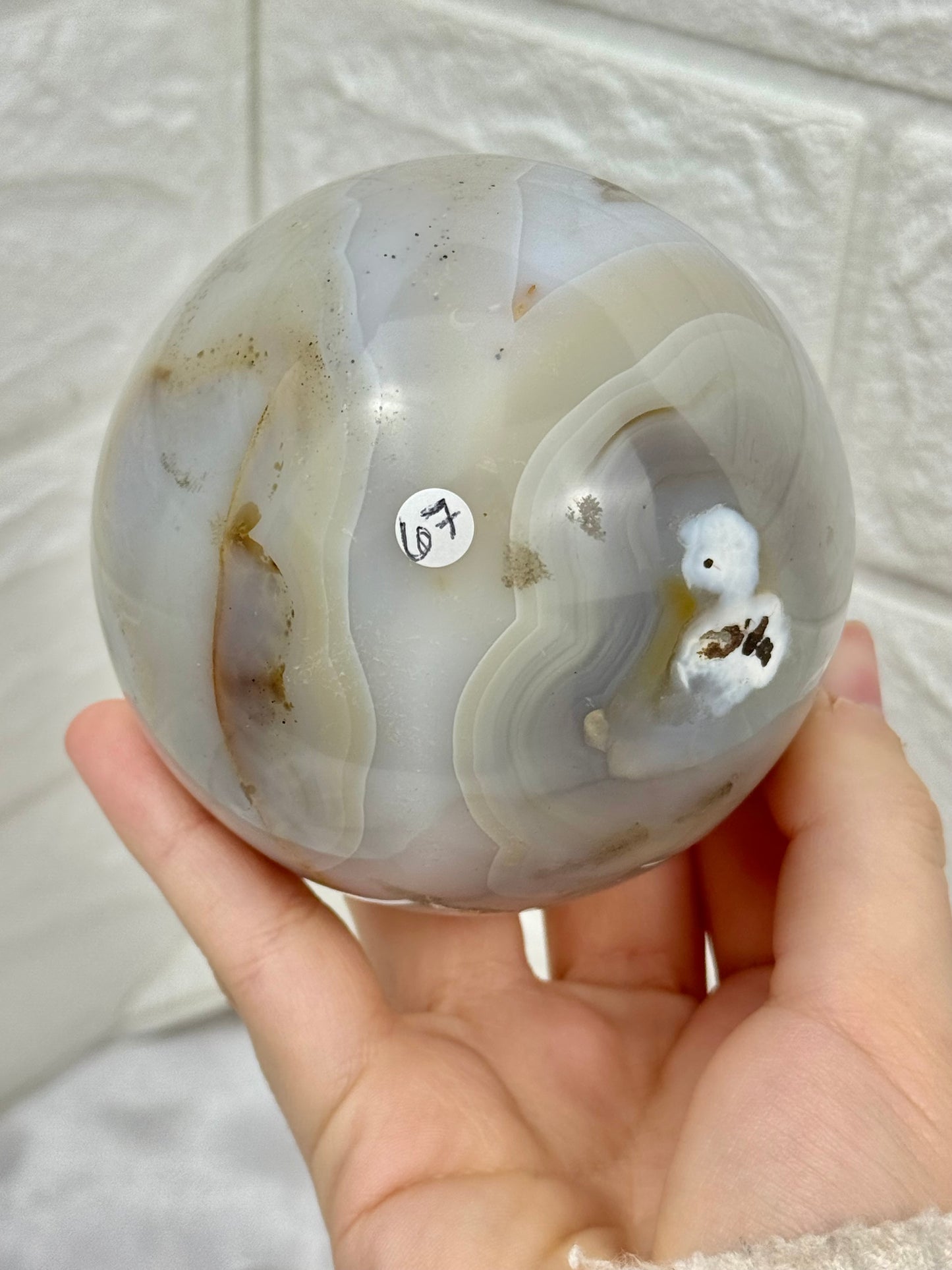 Beautiful banded agate sphere with druzy from Brazil