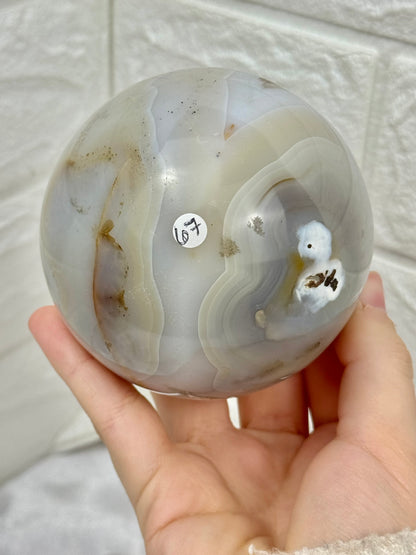 Beautiful banded agate sphere with druzy from Brazil