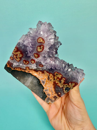 Stunning purple amethyst stalactite slab with peach jasper on stand from Uruguay