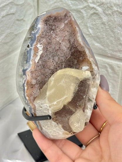 Pink amethyst with calcite on stand from Brazil