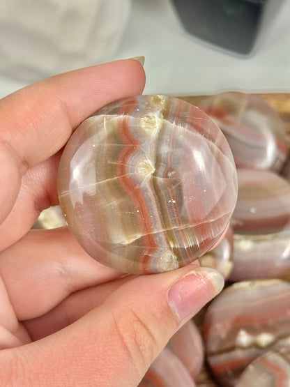 1 pink banded calcite “cookie” flat stone