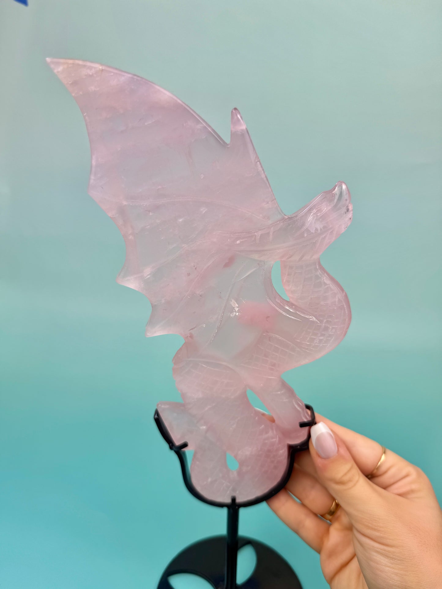 Stunning rose quartz dragon on black stand