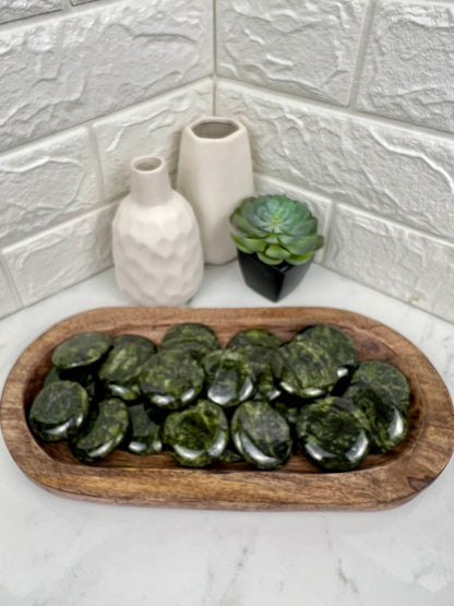 1 dark green serpentine “cookie” flat stone