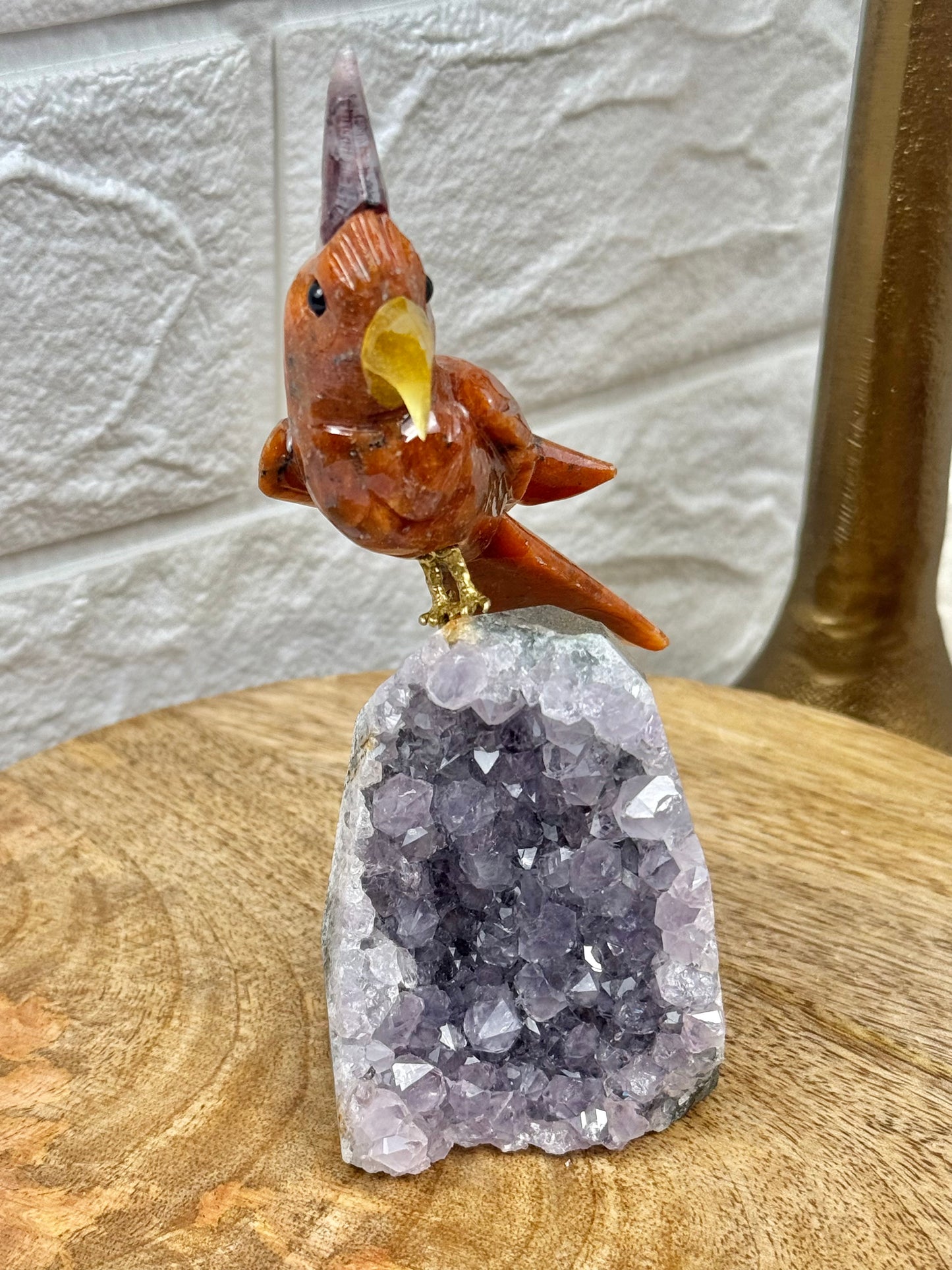 Orange crystal bird carving on amethyst cutbase from Brazil