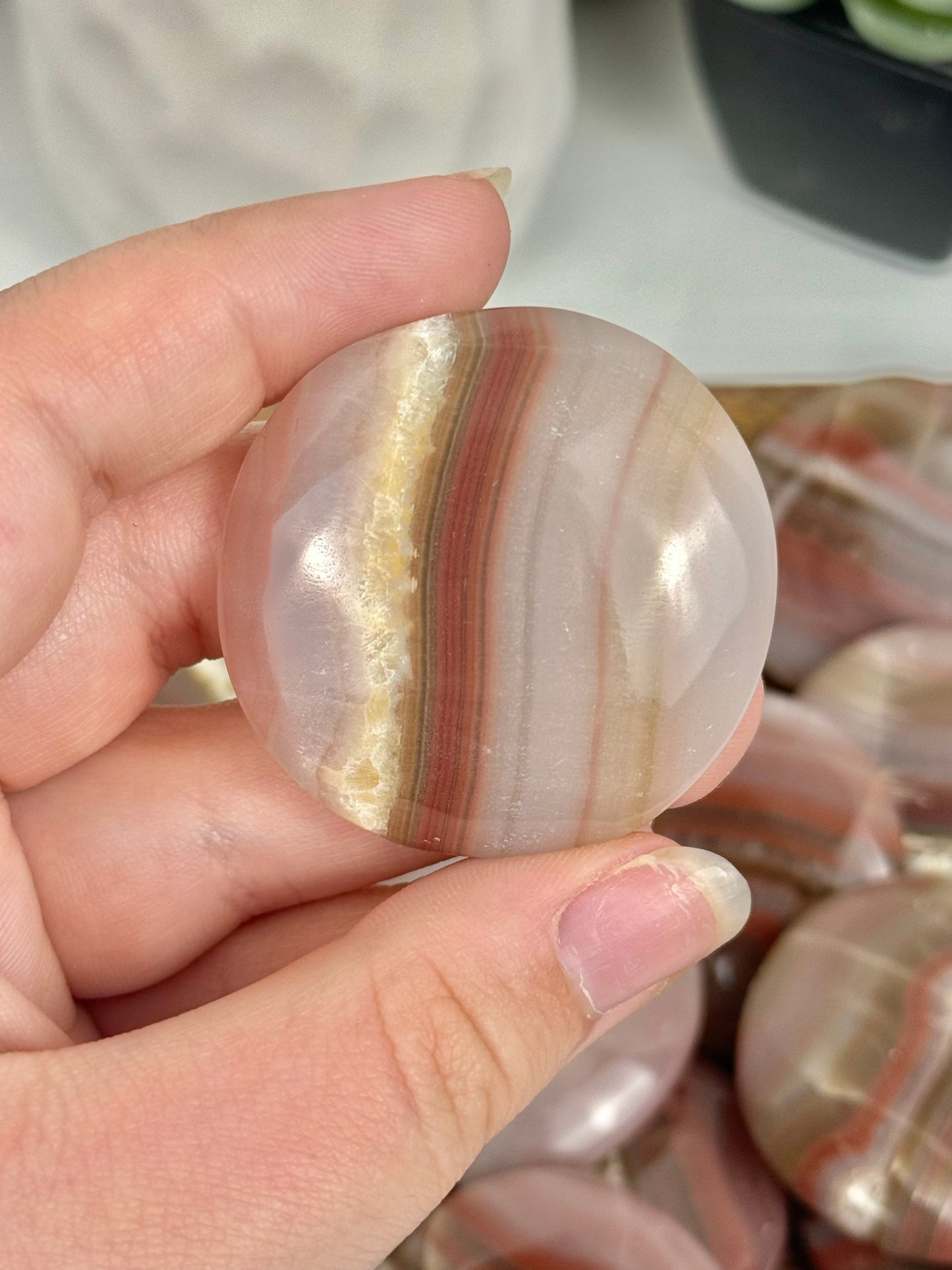 1 pink banded calcite “cookie” flat stone